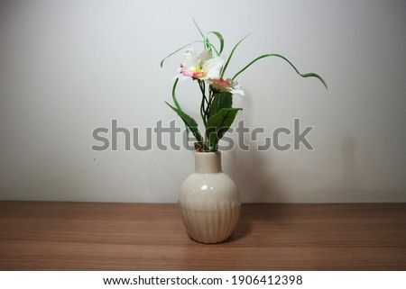White orchid flowers in vintage vase on wooden table, floor, gray cement wall Stylish stock image format for banner templates, text artwork, quotes, fonts, festivals