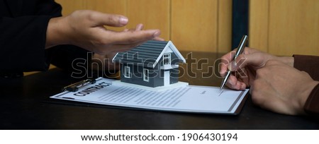 The real estate agent is explaining the home model and the details of the contract with the buyer, the contract concept. Trading houses and real estate