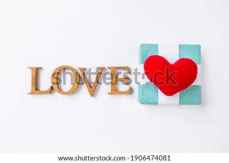 Vlentine gift concept, happy valentine card background idea, love wooden font with red heart on gift box, love and romance concept