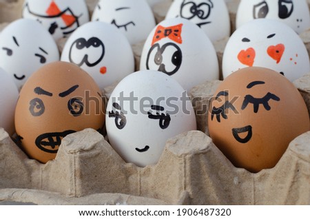 Political concept with a gloomy face on a chicken egg. Painted egg in the kitchen.
