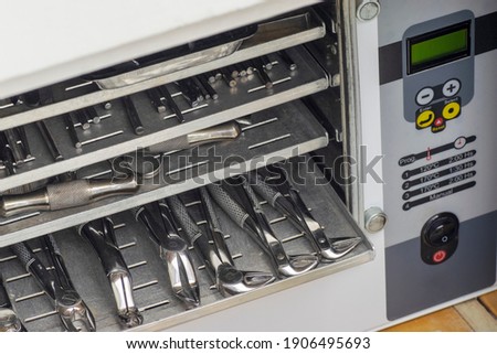 Dry heat oven for dental surgery forceps sterilization Royalty-Free Stock Photo #1906495693