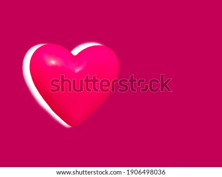 Pink heart shaped plastic plates overlaid with the head in white on a pink background for valentine day.