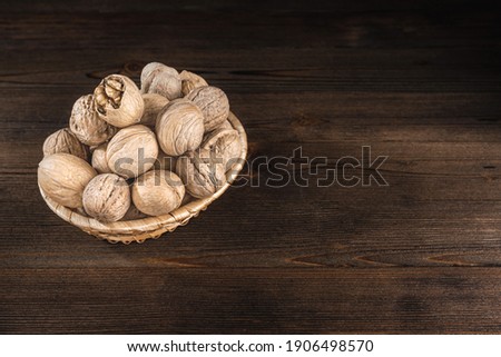 Walnuts on a dark wooden background, top view, copy space