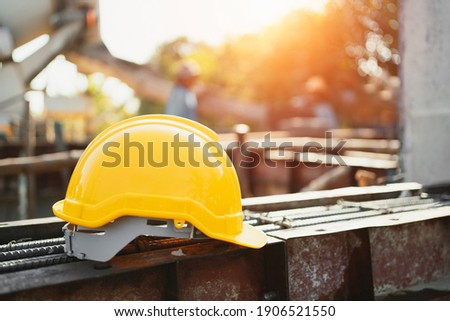 yellow helmet on steel in construction site Royalty-Free Stock Photo #1906521550