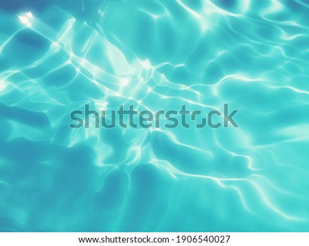 Blur​ abstract​ of​ surface​ blue​ water. Abstract​ of​ surface​ blue​ water​ reflected​ with​ sunlight​ for​ background. Blue​ sea. Blue​ water.​ Water​ splashed​ use​ for​ graphic​ design. Water