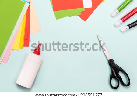 Top view over paper cut tools, scissors, cutter, cutting mat, and crafted paper objects. DIY trendy project concept. Flat lay. Royalty-Free Stock Photo #1906551277