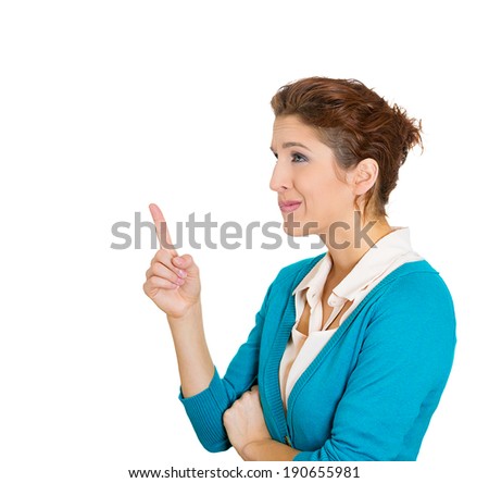 Closeup side view portrait, thoughtful young woman pointing with index finger, looking, having right solution direction, isolated white background. Human facial expression, feeling, attitude, reaction