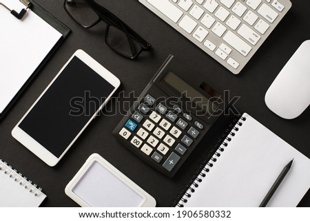 Top above overhead flat lay view photo of office set stuff objects accessories laptop eyeglasses notebook cellphone laying isolated black color backdrop