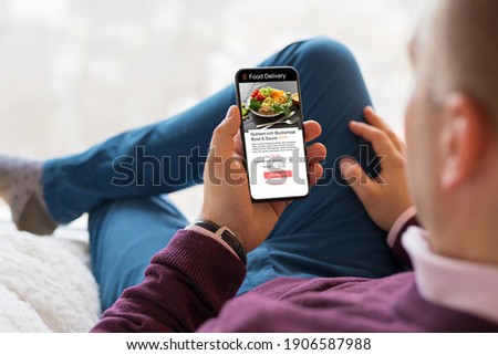 Man choosing a meal on food delivery app