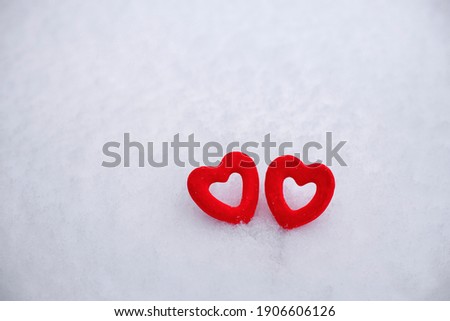 valentine's day background, 2 red velvet hearts on white fluffy snow, snow texture, 14 february