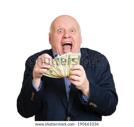 Closeup portrait, happy, excited successful senior lucky elderly man holding money dollar bills in hand isolated white background. Positive emotion facial expression feeling. Financial reward savings