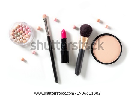 Professional makeup on a white background. Brushes, lipstick and other products, a flat lay