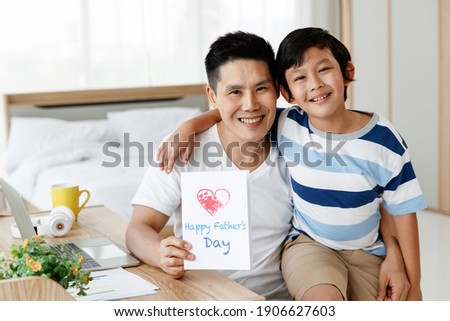 Asian family I love you, dad! Handsome man at home with his little boy. Happy Father's Day. Concept Greeting card