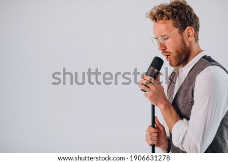 Singer with microphone singing in studio