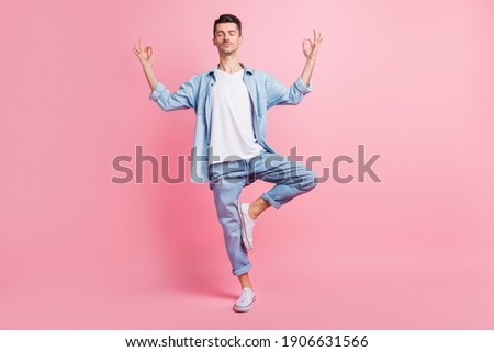 Full length photo of calm peaceful man make om sign weekend rest isolated on pastel pink color background
