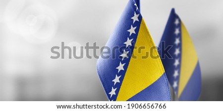 National flag of the Bosnia and Herzegovina on dark fabric Royalty-Free Stock Photo #1906656766