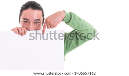 Happy Asian man holding whiteboard pointing with his finger. Isolated on white background
