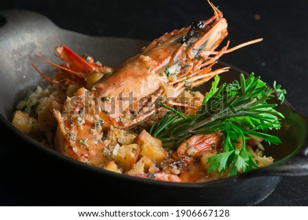 Grilled shrimp. Shrimp grilled in garlic, butter, shallots and wine. Classic traditional American or French cuisine. Served with steamed organic vegetables, broccoli carrots cauliflower and lemons.