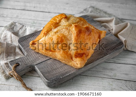 Puff pastry bun stuffed with apples, berries, or cottage cheese and potatoes, mini pie. Bakery products. Sweet pastry.