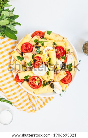 top view of italian pasta salad on white background	