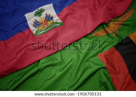 waving colorful flag of zambia and national flag of haiti. macro