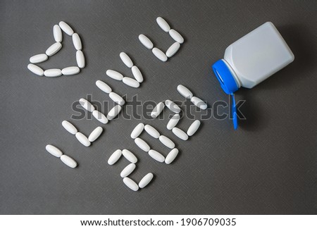 "I love you. 2021" words are laid out by medicinal pills on the dark gray background. Flat lay. Close-up.
