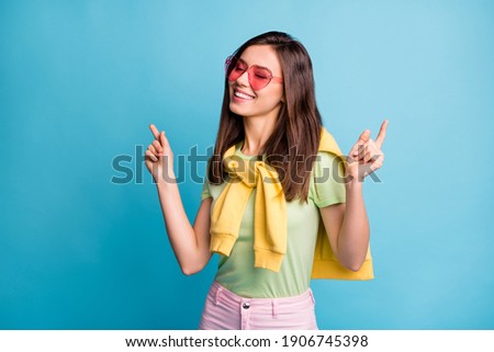 Photo of carefree person closed eyes wear pink heart glasses tied on shoulders sweater isolated on blue color background