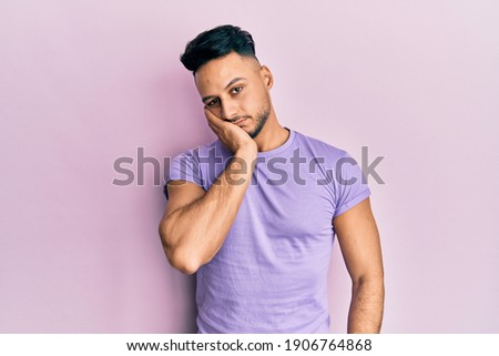 Young arab man wearing casual clothes thinking looking tired and bored with depression problems with crossed arms. 