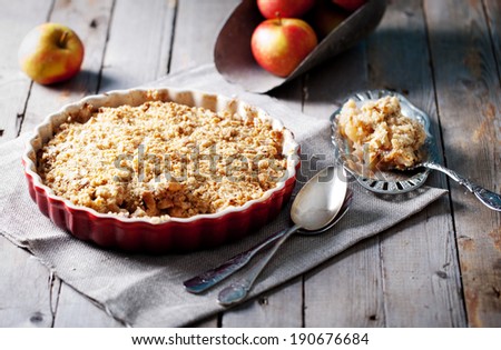 Apple crumble on the wooden background with apples . Royalty-Free Stock Photo #190676684