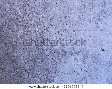 Smooth gray concrete surface, not treated, porous.