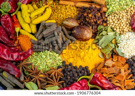 Various spices, peppers and herbs close-up top view. Eastern spice market. A set of peppers and spices for cooking. Royalty-Free Stock Photo #1906776304