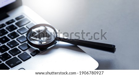 Laptop computer with magnifying glass. Internet search concept. 