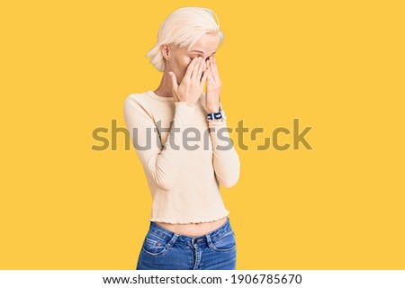 Young blonde woman wearing casual clothes rubbing eyes for fatigue and headache, sleepy and tired expression. vision problem 