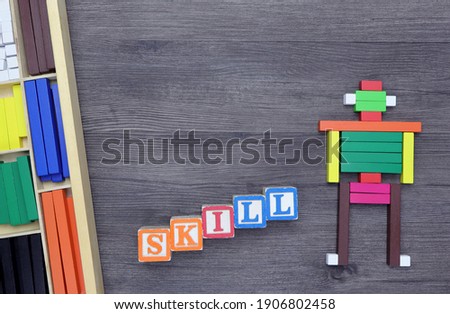 SKILL word written on wood block and Cuisenaire Rods on the table