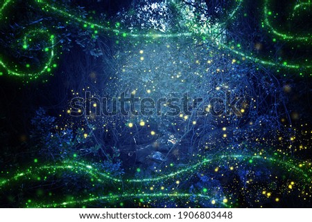 Abstract and magical image of Firefly flying in the night forest. Fairy tale concept Royalty-Free Stock Photo #1906803448