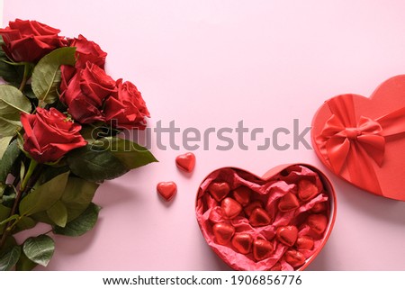 Red chocolate sweets and roses on pink for Valentine's day. Greeting card with copy space. Royalty-Free Stock Photo #1906856776