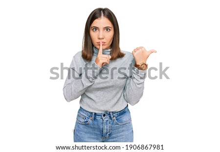 Young beautiful woman wearing casual turtleneck sweater asking to be quiet with finger on lips pointing with hand to the side. silence and secret concept. 