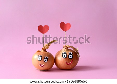 
Loving cartoon couple of vegetables with hearts on a pink background. Valentine's card.
