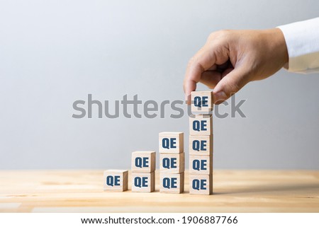 Quantitative easing or economy concepts with qe sign Increase.crisis and solution Royalty-Free Stock Photo #1906887766
