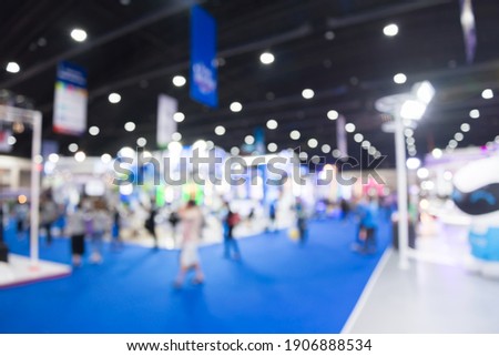 Abstract blur people in exhibition hall event trade show expo background. Large international exhibition, convention center, business marketing and event fair organizer concept. Royalty-Free Stock Photo #1906888534
