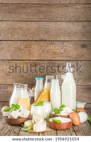 Set of Various Fresh Dairy Products - milk, cottage cheese, cheese, eggs, yogurt, sour cream, butter on wooden background Royalty-Free Stock Photo #1906921054