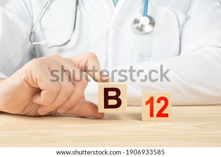 essential vitamins and minerals for humans. doctor recommends taking vitamin b12. doctor talks about the benefits of vitamin b12. B12 Vitamin - Health Concept. B12 alphabet on wood cube. Royalty-Free Stock Photo #1906933585