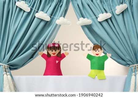 Creative puppet show on white stage indoors Royalty-Free Stock Photo #1906940242