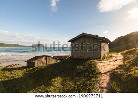Fishers houses on the paradise beach on the sunrise light
