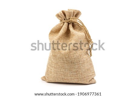 A jute bag full of money isolated on a white background. Royalty-Free Stock Photo #1906977361