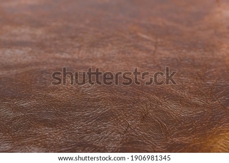 Grunge old brown leather texture background, macro, selective focus. Background for your text, inscription or picture. Abstract background.Abstract background.