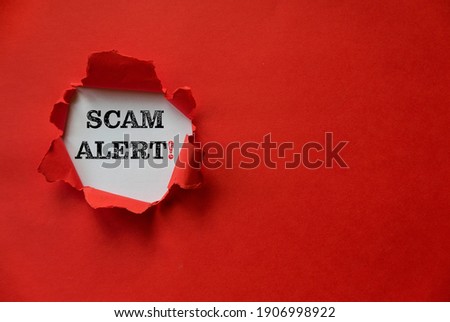 Red torn paper with a text of Scam Alert with copy space. Royalty-Free Stock Photo #1906998922