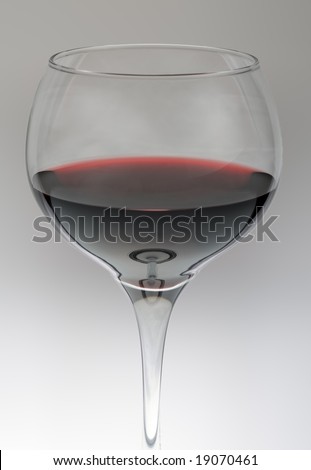 Glass of red wine against grey gradient background
