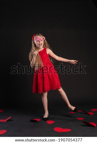 The mask goggles hearts Valentine background, blackboard , on the floor of the hearts are lovely . the art form. day, frame in red dress girl, barefoot