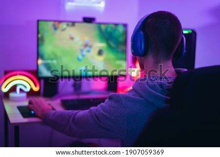 Young gamer playing online video games while streaming on social media - Youth people addicted to new technology game Royalty-Free Stock Photo #1907059369